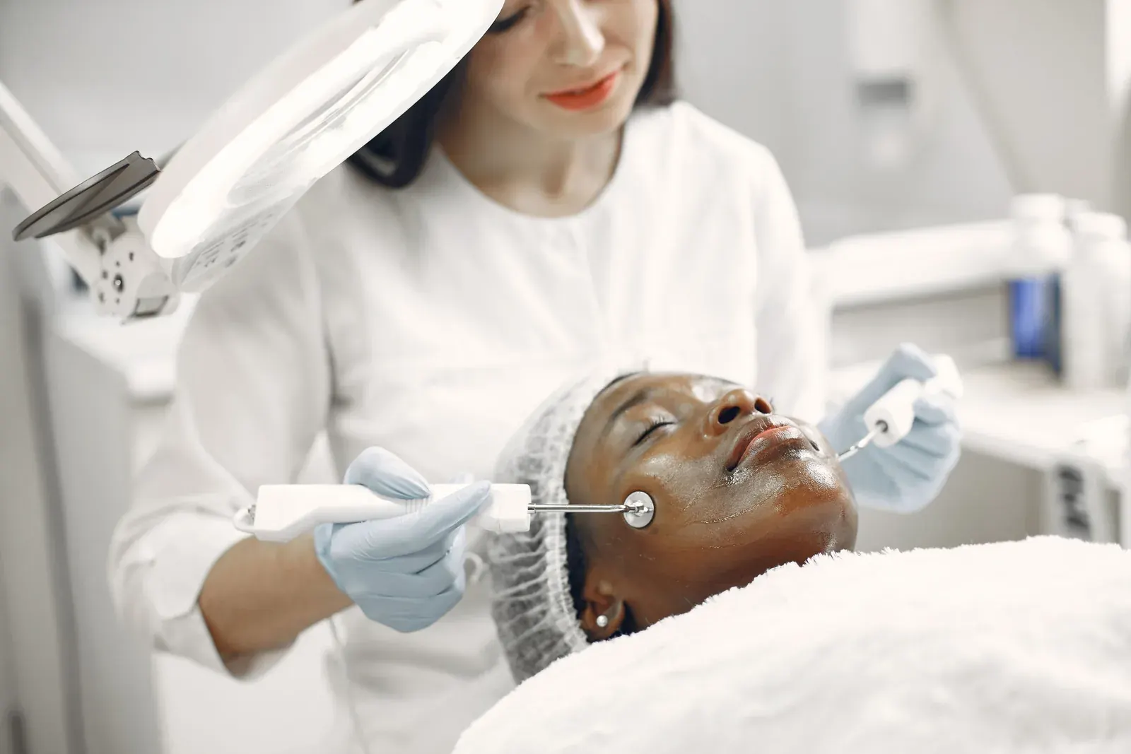 A facial treatment in a clinic room.